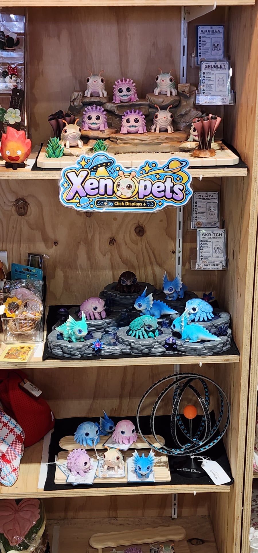 Elsewhere Oddities Xenopet stall at Marketfair, with desert and rockpool shelves and adoption certificates